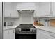 Clean white kitchen featuring quartz countertops, white cabinetry, and stainless steel appliances at 14007 Middleton Way, Tampa, FL 33624