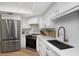 Modern kitchen featuring stainless steel appliances, white cabinetry, and quartz countertops at 14007 Middleton Way, Tampa, FL 33624