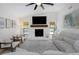 Cozy living room featuring a white stone fireplace, comfortable seating, and an abundance of natural light at 14007 Middleton Way, Tampa, FL 33624