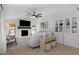 Comfortable living room with a fireplace, built in bookcase, ceiling fan, and lots of seating at 14007 Middleton Way, Tampa, FL 33624