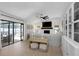 Open-concept living room with white stone fireplace, comfortable seating, and sliding glass doors leading to the patio at 14007 Middleton Way, Tampa, FL 33624