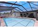 Backyard pool surrounded by a screened enclosure, patio seating and outdoor living area at 14007 Middleton Way, Tampa, FL 33624