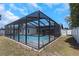 Enclosed pool area with black frame and outdoor view, perfect for relaxation and recreation at 14007 Middleton Way, Tampa, FL 33624