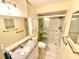 Bright bathroom featuring a shower, vanity, and updated fixtures at 1473 Feather Dr # 1473, Clearwater, FL 33759