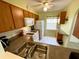 Well-equipped kitchen featuring wood cabinets, white appliances, and ample counter space at 1473 Feather Dr # 1473, Clearwater, FL 33759