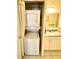 Convenient laundry area with stacked washer and dryer unit and a utility sink at 1473 Feather Dr # 1473, Clearwater, FL 33759