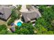 Aerial view of the home featuring a private pool, deck, and lush surrounding greenery at 14809 Ninebark Ct, Land O Lakes, FL 34638