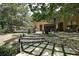 Backyard featuring an entertainment area, lush grass, landscaping, and stone steps at 14809 Ninebark Ct, Land O Lakes, FL 34638