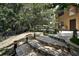 Spacious backyard with stone steps, seating area, mature trees, and lush landscaping at 14809 Ninebark Ct, Land O Lakes, FL 34638
