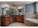 Elegant bathroom with double vanity, soaking tub, and tiled shower at 14809 Ninebark Ct, Land O Lakes, FL 34638