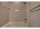 Standard bathtub with shower head, tile surround, and towel rack at 14809 Ninebark Ct, Land O Lakes, FL 34638