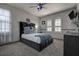 Comfortable bedroom featuring a bed with a velvet headboard and modern gray walls at 14809 Ninebark Ct, Land O Lakes, FL 34638