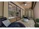 Relaxing covered patio with two chaise lounges, brick pavers, and ceiling fan at 14809 Ninebark Ct, Land O Lakes, FL 34638