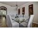 Bright dining room with glass top table, decorative chandelier, and hardwood floors at 14809 Ninebark Ct, Land O Lakes, FL 34638