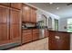 Kitchen with custom wood cabinets, tile backsplash, stainless steel appliances, and granite countertops at 14809 Ninebark Ct, Land O Lakes, FL 34638
