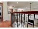 Open-concept living room features a fireplace and modern decor, viewed from an upstairs landing with hardwood floors at 14809 Ninebark Ct, Land O Lakes, FL 34638