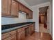 Office area with wood cabinets, granite countertop, and wooden floors at 14809 Ninebark Ct, Land O Lakes, FL 34638