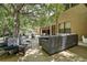 Outdoor patio area under shady trees with ample seating, ideal for entertaining and leisure at 14809 Ninebark Ct, Land O Lakes, FL 34638