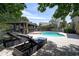 Beautiful in-ground pool with lounging chairs and an outdoor kitchen for entertaining on the brick patio at 14809 Ninebark Ct, Land O Lakes, FL 34638