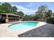 Inviting pool area with covered outdoor bar and ample patio space for entertaining at 14809 Ninebark Ct, Land O Lakes, FL 34638