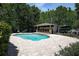 An in-ground pool with an outdoor kitchen provides a great area to entertain in this well-maintained yard at 14809 Ninebark Ct, Land O Lakes, FL 34638
