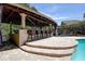 Poolside bar with seating, perfect for outdoor entertaining and relaxation at 14809 Ninebark Ct, Land O Lakes, FL 34638