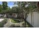 Backyard putting green with well-manicured lawn and privacy fence at 14809 Ninebark Ct, Land O Lakes, FL 34638