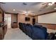 Home theater room with seating, a projector screen, and dim lighting at 14809 Ninebark Ct, Land O Lakes, FL 34638