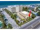 A Bird's-eye view of Beachside Villas showing proximity to the beach and immaculate landscaping at 1500 Gulf Blvd # 103B, Indian Rocks Beach, FL 33785