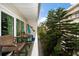 Balcony featuring outdoor seating and lush landscaping, perfect for relaxation and privacy at 1500 Gulf Blvd # 103B, Indian Rocks Beach, FL 33785