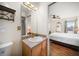 Bathroom with vanity, glass shower, and access to the main bedroom at 1500 Gulf Blvd # 103B, Indian Rocks Beach, FL 33785