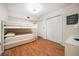 Bedroom with bunkbeds, closet and laminate flooring at 1500 Gulf Blvd # 103B, Indian Rocks Beach, FL 33785