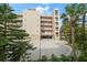 Building exterior showcasing a well-maintained facade, balconies, and covered parking at 1500 Gulf Blvd # 103B, Indian Rocks Beach, FL 33785
