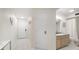 Bright hallway leading to a stylish bathroom with modern fixtures and neutral tones at 1500 Gulf Blvd # 103B, Indian Rocks Beach, FL 33785