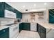 A modern, sleek kitchen featuring bright cabinetry, countertops, and stainless steel appliances at 1500 Gulf Blvd # 103B, Indian Rocks Beach, FL 33785