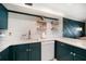 Well-appointed kitchen with modern countertops, open shelving, and updated appliances at 1500 Gulf Blvd # 103B, Indian Rocks Beach, FL 33785