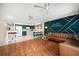 Spacious open-concept living area featuring modern accents, hardwood floors and lots of natural light at 1500 Gulf Blvd # 103B, Indian Rocks Beach, FL 33785