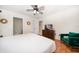 The main bedroom features ensuite bath access, a ceiling fan, and laminate flooring at 1500 Gulf Blvd # 103B, Indian Rocks Beach, FL 33785