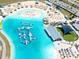 Aerial view showcases the lagoon's clear water, beach area, and recreational water inflatables at 16810 Trite Bend St, Wimauma, FL 33598