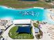 Aerial view of the community lagoon featuring a large water park, white sand beach, and several lounge areas at 16810 Trite Bend St, Wimauma, FL 33598