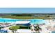 Aerial view of the lagoon showcasing the splash park, beach, and many community amenities for residents enjoyment at 16810 Trite Bend St, Wimauma, FL 33598