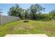 Large backyard with an incomplete lawn and perimeter fencing at 16810 Trite Bend St, Wimauma, FL 33598