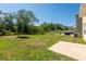 Expansive backyard featuring a patio area, lush greenery, and plenty of space for outdoor enjoyment at 16810 Trite Bend St, Wimauma, FL 33598