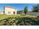 Spacious backyard featuring a well-maintained lawn, a privacy fence, and mature trees at 16810 Trite Bend St, Wimauma, FL 33598