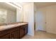 Bathroom featuring double sinks with granite countertops, and a walk-in shower at 16810 Trite Bend St, Wimauma, FL 33598