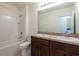 Bathroom with double sinks, tiled floors, a bathtub and shower at 16810 Trite Bend St, Wimauma, FL 33598