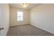 This carpeted bedroom includes a window for natural light and a ceiling fan at 16810 Trite Bend St, Wimauma, FL 33598