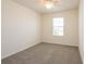 This carpeted bedroom includes a window and a ceiling fan at 16810 Trite Bend St, Wimauma, FL 33598