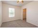 Bedroom featuring a ceiling fan, window, and walk-in closet at 16810 Trite Bend St, Wimauma, FL 33598