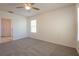 Bedroom with carpet, ceiling fan, and a view to ensuite bathroom at 16810 Trite Bend St, Wimauma, FL 33598
